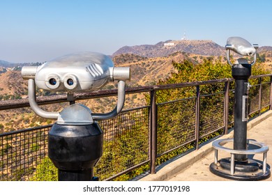 Los Angeles, California. Empty Park, No People. Coin Operated Binoculars With Hollywood Sign Blurred In Background. Famous American Landmark Tourist Attraction.