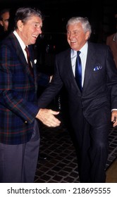 LOS ANGELES, CALIFORNIA - Exact Date Unknown - Circa 1991:  Ronald Reagan And Merv Griffin Laughing And Talking At The Beverly Hilton Hotel