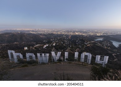 LOS ANGELES, CALIFORNIA - July 2, 2014:  Back of the Hollywood sign above the city of Los Angeles at dusk.  