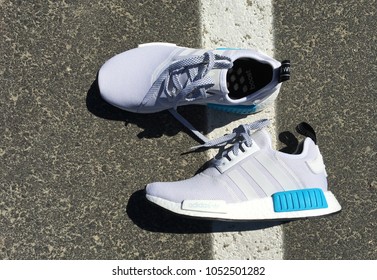 LOS ANGELES, CALIFORNIA - JULY 22, 2016: Adidas NMD R1 Bright Cyan White and blue Shoes on street.