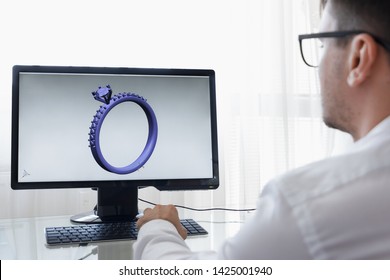 LOS ANGELES, CALIFORNIA - JUNE 3, 2019: Engineer, Constructor, Designer, Architect in Glasses Working on a Personal Computer. He Creating New Design of Golden Ring in CAD Program. Freelance Work. An