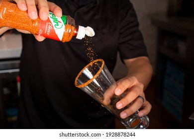 Los Angeles, California, United States - 02-24-2021: A View Of A Bartender Preparing A Cocktail Featuring Tajin Garnished Around The Rim Of The Glass.