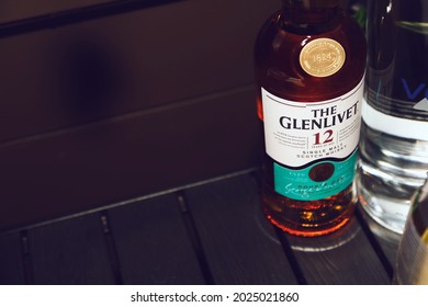 Los Angeles, California, United States - 08-10-2021: A view at a bottle of Glenlivet Scotch Whisky 12 Year on a table, on the right side of the frame.