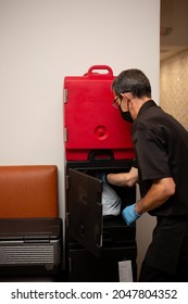 Los Angeles, California, United States - 08-24-2021: A View Of A Restaurant Employee Placing A To-go Order Into A Cambro Food Locker.