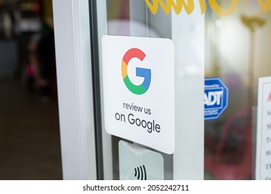Los Angeles, California, United States - 10-02-2021: A view of a retail store window sticker advertising reviews available on customers to provide reviews on Google.