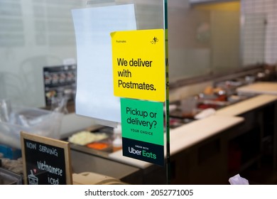 Los Angeles, California, United States - 10-02-2021: A View Of Window Stickers Advertising The Availability Of Food Delivery Service Through Postmates And Uber Eats, Seen At A Local Restaurant.