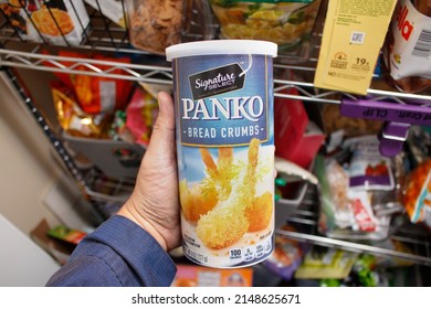 Los Angeles, California, United States - 03-01-2022: A View Of A Hand Holding A Container Of Signature Select Panko Bread Crumbs, In Front Of A Home Pantry.