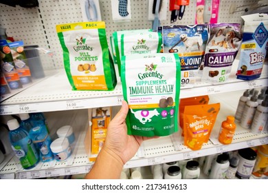 Los Angeles, California, United States - 05-20-2022: A View Of A Hand Holding A Package Of Greenies Supplements Immune Health, On Display At A Local Department Store.