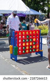 Los Angeles, California, United States - 05-20-2022: A View Of People Playing A Giant Game Of Connect Four, Seen At A Local Carnival.