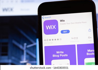 Los Angeles, California, USA - 12 February 2020: Mobile phone with Wix icon on screen close up with website on laptop. Blurred background with Wix.com site, Illustrative Editorial