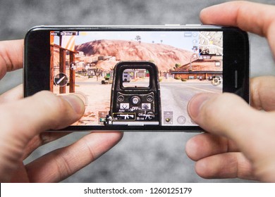 Los Angeles, California, USA - 17 December 2018: Hands Holding A Smartphone With PUBG FPS Game