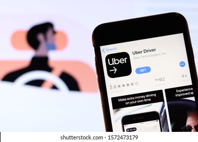 Los Angeles, California, USA - 27 November 2019: Uber Driver App Icon On Mobile Phone Screen With Blurry Website On Laptop, Illustrative Editorial