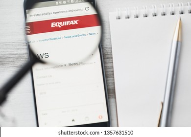 Los Angeles, California, USA - 3 April 2019: Equifax Official Website Homepage Under Magnifying Glass. Concept Equifax Credit Risk Assessment Logo Visible On Smartphone, Tablet Screen