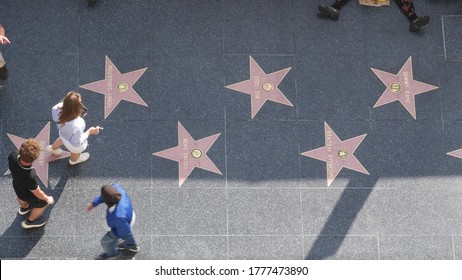 LOS ANGELES, CALIFORNIA, USA - 7 NOV 2019: Walk Of Fame Promenade On Hollywood Boulevard In LA. Pedastrians Walking Near Celebrity Stars On Asphalt. Walkway Floor Near Dolby And TCL Chinese Theatre.