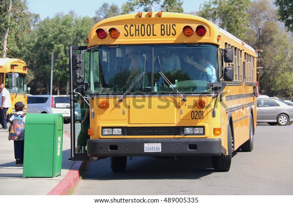 Los Angeles, California, USA - April 20, 2016:\
School Bus is dropping off students and teachers at a zoo for the\
school trip.