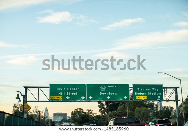 Los Angeles, California /\
USA - August 21, 2019: On freeway 110 south. Signage of the\
billboard with Downtown Los Angeles and Civil Center to China town.\
Morning traffic.