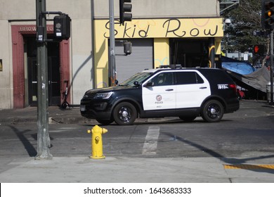 Los Angeles, California, U.S.A - December, 28 2019: Skid Row, Los Angeles's homeless center. Police patrol the are by the iconic Skid Row corner store.