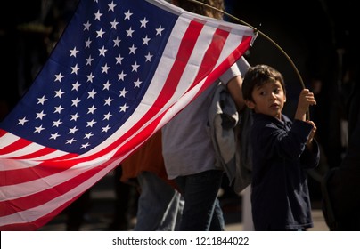 Los Angeles, California / USA - January 18, 2017: A Young Latino Boy Holds An American Flag During An Immigration March In Downtown Los Angeles.