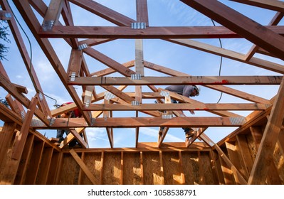 Los Angeles, California USA. March 19, 2018. New Construction Modern Home With Construction Worker Working On The Installation Of Roof Framing As Part Of The Framing Process