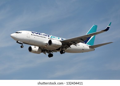 LOS ANGELES, CALIFORNIA, USA - MARCH 21, 2013.   West Jet Boeing 737-7CT  Lands At Los Angeles Airport On March 21, 2013 In Los Angeles, CA. The Plane Has A Range Of 6,340 Miles With 177 Seats.