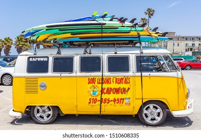 Los Angeles California USA. May 30, 2019. Venice Beach, Surf Boards Stacked On A Yellow Van Roof, Surf School Adv, Sunny Spring Day