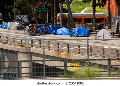 Los Angeles, California / USA - May 1, 2020: A homeless encampment crowds the sidewalk of Arcadia Street in Downtown Los Angeles.