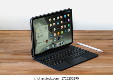 Los Angeles, California / USA - May 5, 2020: Minimal Desk Setup With An Apple IPad And An Apple Pencil On An Apple Magic Keyboard On A Wooden Desk Against White Wall