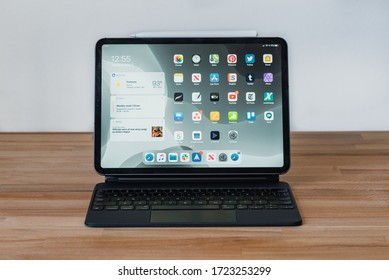 Los Angeles, California / USA - May 5, 2020: Minimal Desk Setup With An Apple IPad And An Apple Pencil On An Apple Magic Keyboard On A Wooden Desk Against White Wall