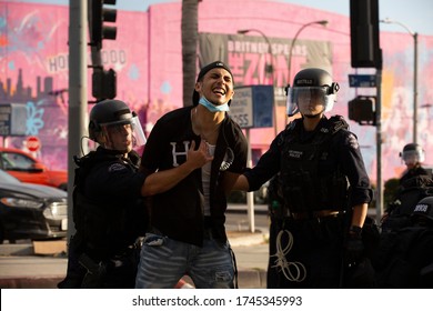 Los Angeles, California / USA - May 30, 2020: An individual protesting the killing of George Floyd is apprehended by Police.