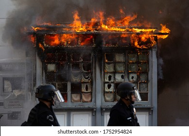 Los Angeles, California / USA - May 30, 2020:  Police watch over a fire set by George Floyd Protesters in the Fairfax District of Los Angeles.