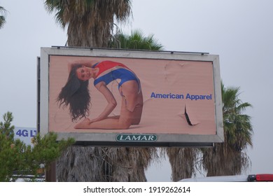 Los Angeles, California, USA - May 28 2014: A Los Angeles Street Corner With A Ubiquitous American Apparel Billboard Featuring A Scantily Clad Woman.