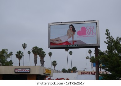 Los Angeles, California, USA - May 28 2014: A Los Angeles Street Corner With A Ubiquitous American Apparel Billboard Featuring A Scantily Clad Woman.