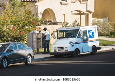 Los Angeles, California, USA - Nov 16, 2020: US Postal Service Worker Delivers Mail To A Community Mailbox In Los Angeles, California