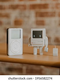 Los Angeles, California, USA - November 12, 2020: Classic Bot Designer Toy Paired With A Retro Apple IPod First Gen On A Desk