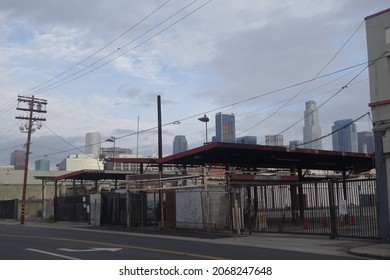 Los Angeles, California, USA - November 30 2014: Los Angeles Downtown Skyline With A Rundown Structure On An Empty Street In The Foreground. Wide Shot, Morning.