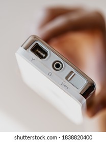 Los Angeles, California / USA - October 20 2020: Female Hand Holding A White Apple IPod First Generation Showcasing The Top Ports Of The Device