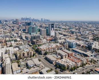 Los Angeles, California, USA – September 13, 2021: LA Koreatown above Western Ave, 6th St, Gramercy Pl, Wilshire Blvd, with apartments, houses, buildings and LA downtown aerial view