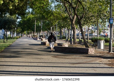 Los Angeles, California USA-June 7, 2020: A Solitary Walker In A Quiet LA County City Park Enjoys Some Peaceful Time In Nature During The Continuing Covid-19 Coronavirus Pandemic.