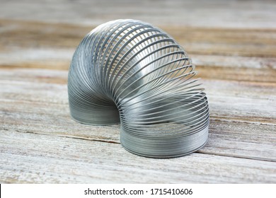 Los Angeles, California/United States - 02/25/2020: A closeup view of a Slinky toy on a wooden surface.