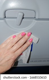 Los Angeles, California/United States Of America: Airline Passenger Wipes Cleans Disinfects Plane Seat Back And Tray Table To Prevent Spread Of Coronavirus, COVID 19, Flu, Germs & Infectious Diseases