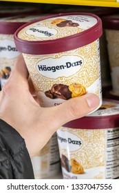 Los Angeles, CA/USA 3/12/2019 - Human Hand Holding A Pint Of Haagen Dazs Ice Cream At A Supermarket Freezer