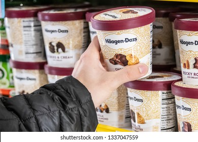 Los Angeles, CA/USA 3/12/2019 - Human Hand Holding A Pint Of Haagen Dazs Ice Cream At A Supermarket Freezer