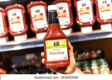 Los Angeles, CA/USA 6/1/2019  Shoppers Hand Holding A Jar Of 365 Whole Foods Brand Organic Ketchup In A Supermarket Alley