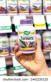 Los Angeles, CA/USA 7-1-2019 Shoppers Hand Holding A Plastic Bottle Of Nature's Way Turmeric Vegetarian Capsules In A Supermarket Aisle