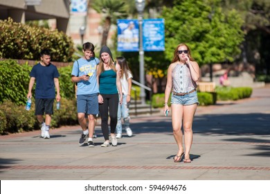 LOS ANGELES, CA/USA - April 27, 2016:  UCLA Students Walking On Bruin Walk.  For Fiscal Year 2016, UCLA Has A Budget Of $6.7 Billion.