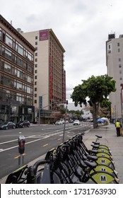 Los Angeles, CA/USA - April 9, 2020: Metro bike share rack and a homeless encampment across from thehHistoric Hotel Cecil in LA now known as Stay on Main