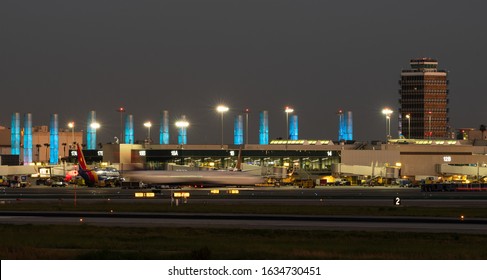 LOS ANGELES, CA/USA - MARCH 17, 2019: the Los Angeles International Airport, LAX, Terminal 1 and the LAX illuminated pylons or light installation. On the right is the old traffic control tower.