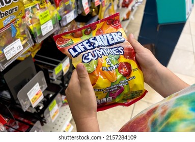 Los Angeles, CA,USA May 15th 2022 Child's Hand Holding A Bag Of Lifesavers Brand Gummies Candy In A Supermarket Aisle