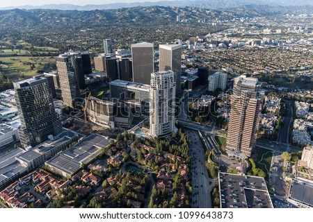 Los Angeles Century City skyline aerial view with Beverly Hills and the Santa Monica Mountains in background.