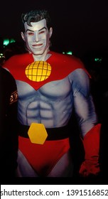 LOS ANGELES - Circa 1991: Actor Woody Harrelson Poses With Costumed Character Captain Planet At An Ecology Fair.